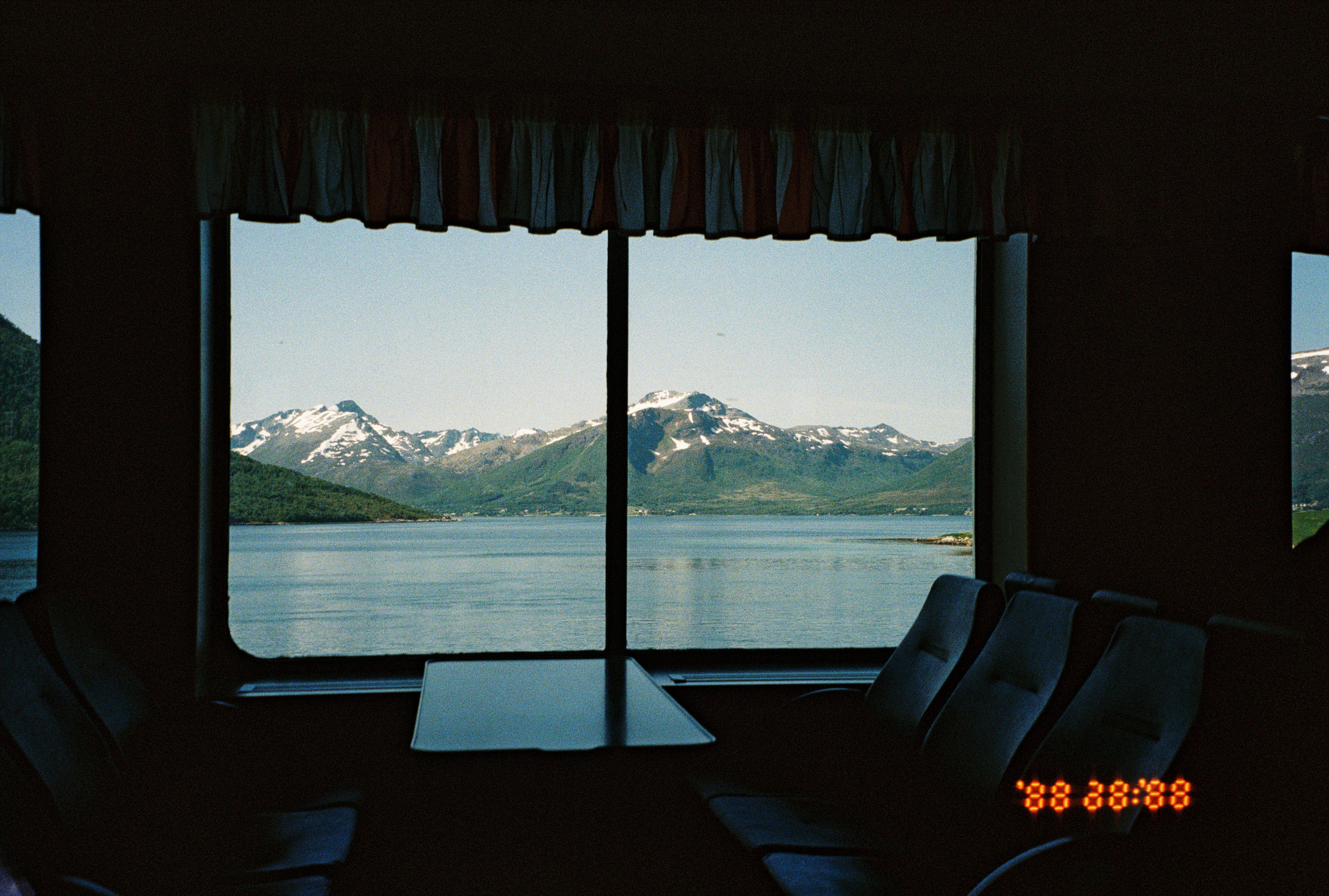 View of a mountain through a window on a ferry