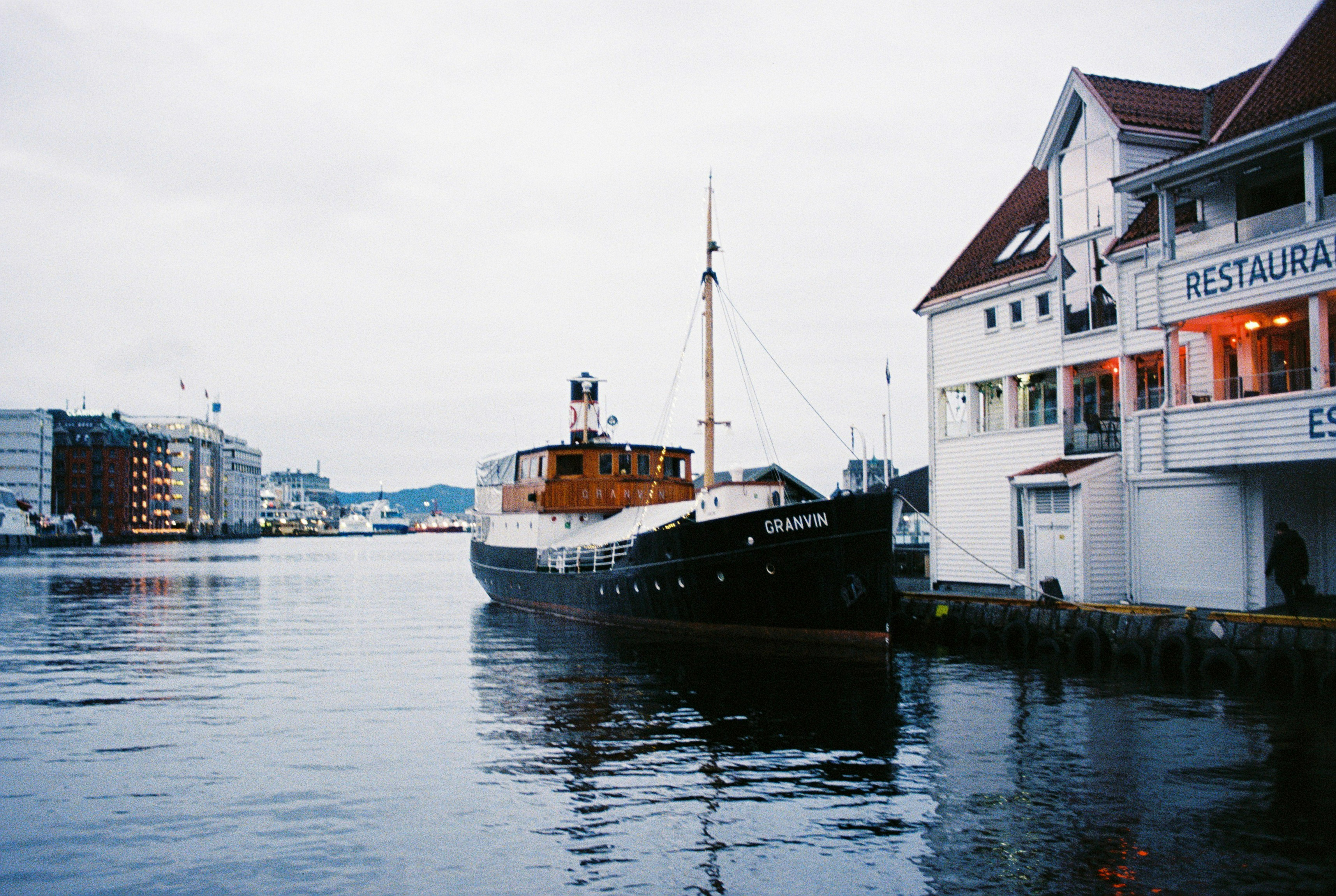 Boat anchored next to a restaurant in Bergen
