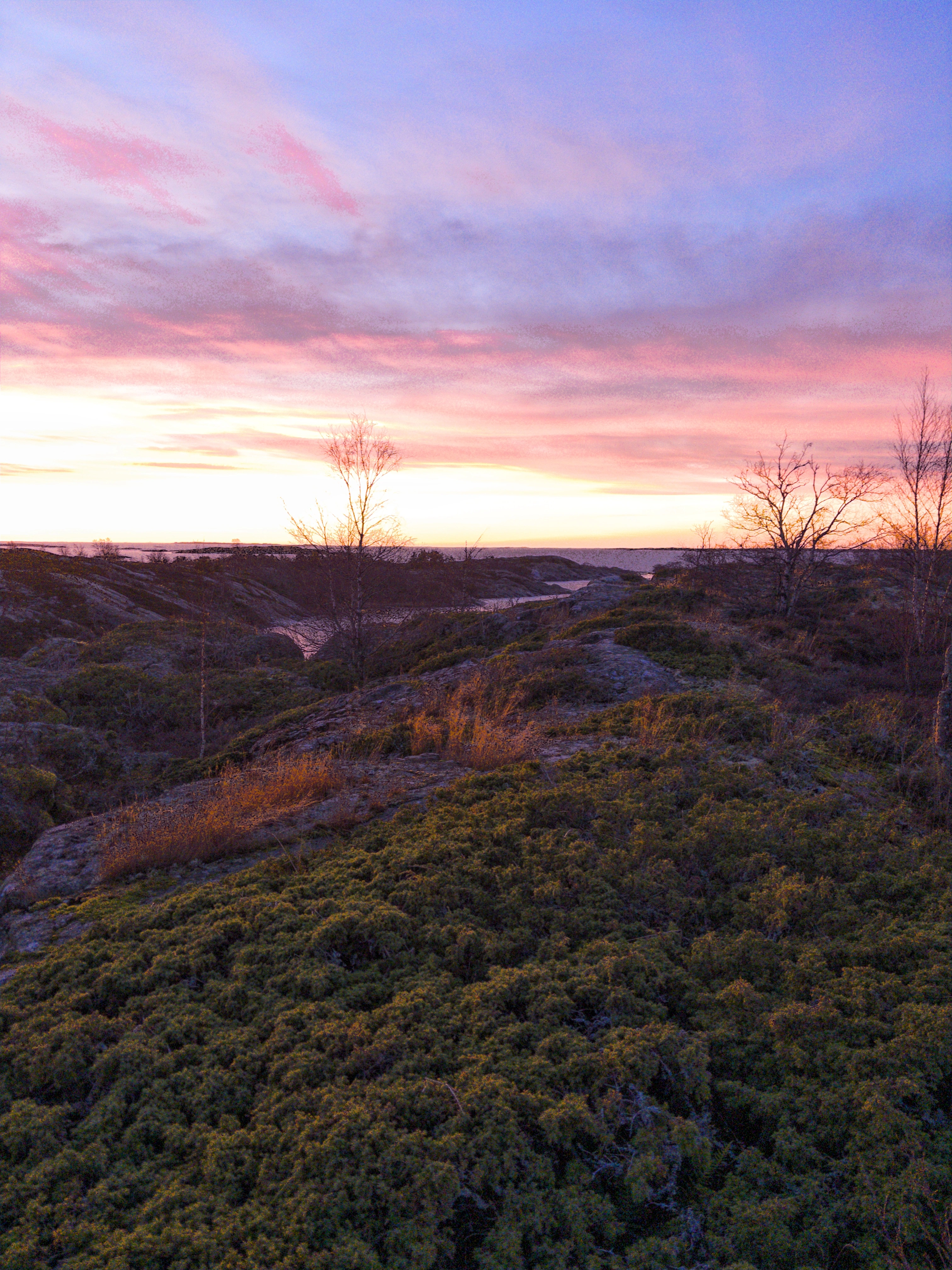 A sunset over an island, rugged landscape